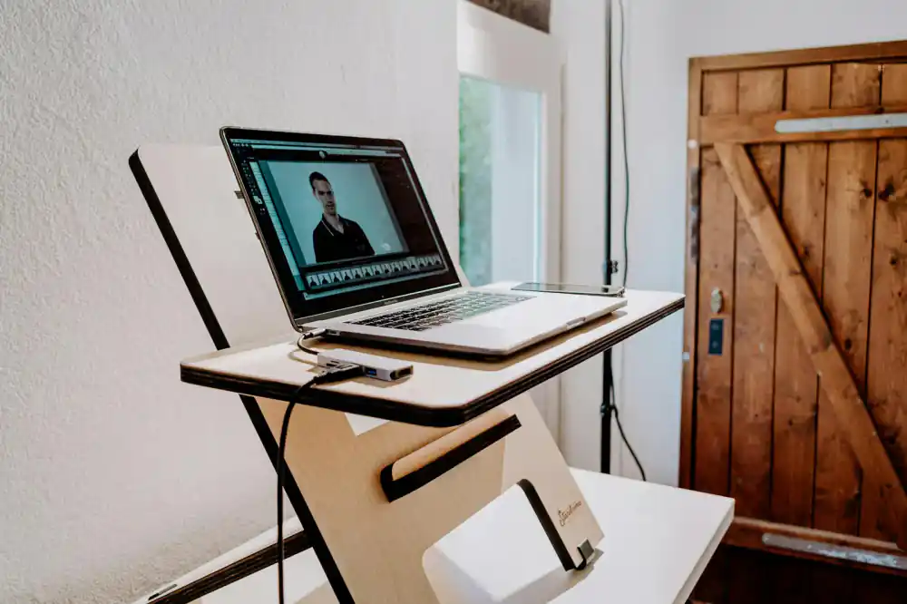 A modern, clean workspace featuring a DeskRise standing desk