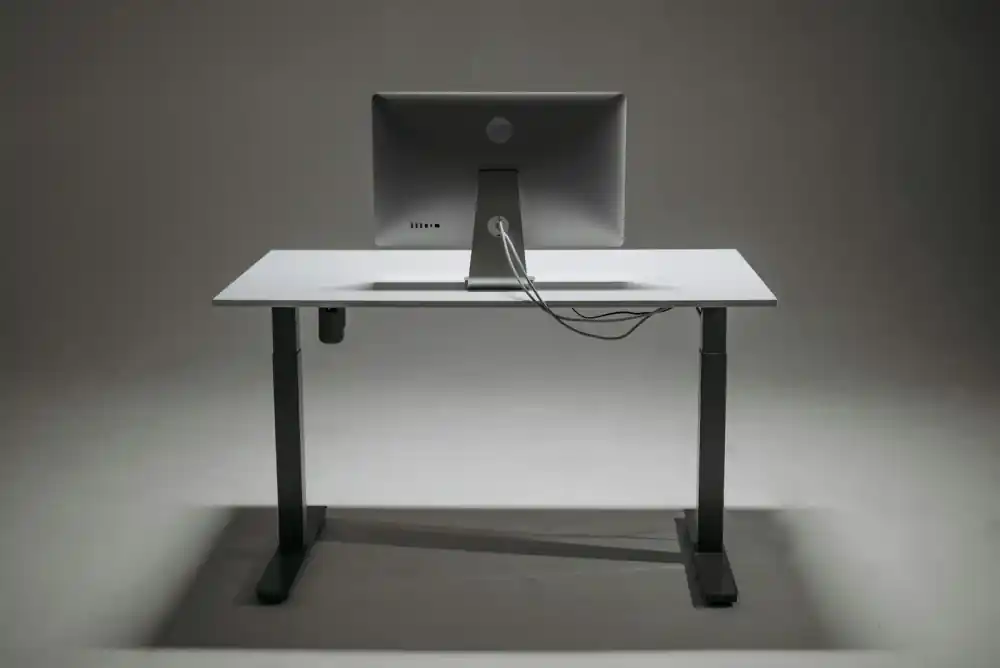 Person adjusting their standing desk height