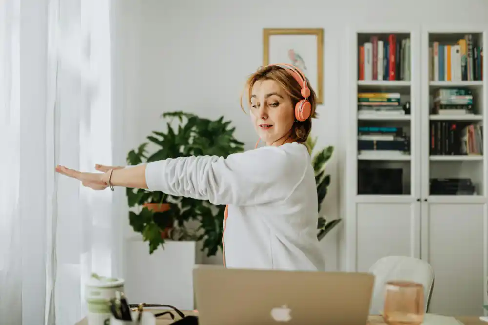 Person doing a gentle stretch at a standing desk